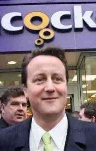 Cameron standing underneath a portion of a sign saying "Cock"