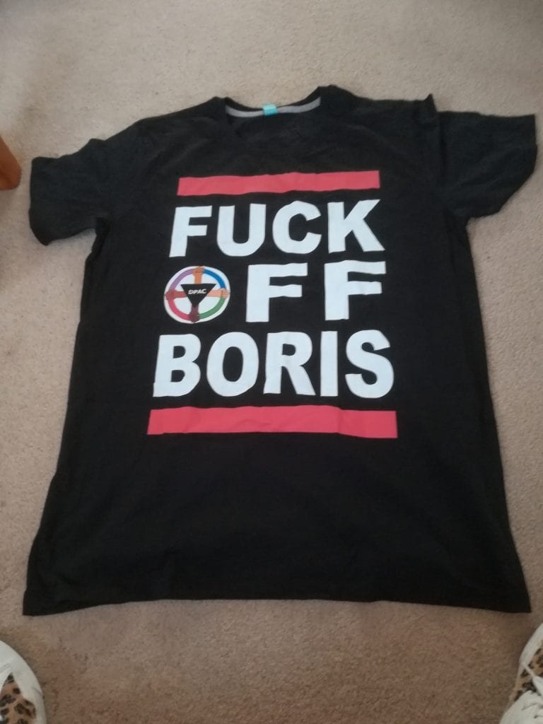 the Fuck Off Boris is the size of the front of the teeshirt with the O of Off being the DPAC logo. They're black and words are enclosed by red lines