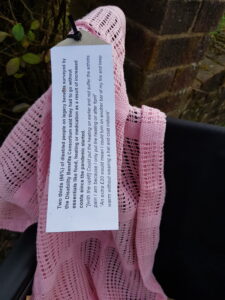 A pink blanket on the arm of a wheelchair